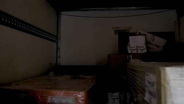 interior of the box of a truck with load and pallet truck