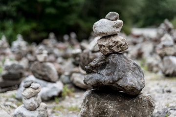 Fototapeta na wymiar Stacks of stones on the riverside in Partnachklamm, Garmisch-Partenkirchen, Germany