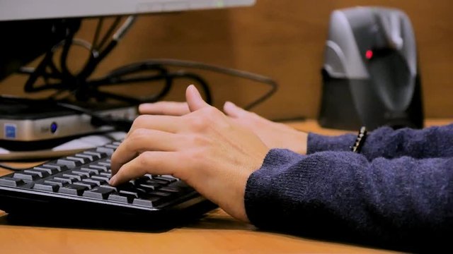 Hands typing on a keyboard