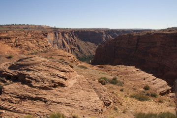 Pylon on a red rock cliff by the Colorado river at Glen Canyon Dam, Page, Arizona.