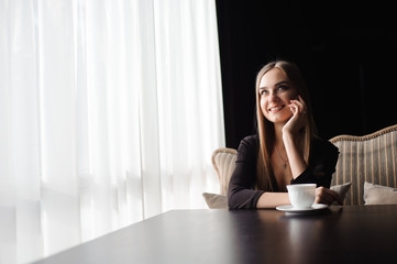 attractive female with cute smile having talking conversation with mobile phone while rest in cafe