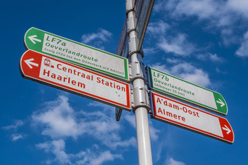 Fototapeta premium Direction signs in Amsterdam on a sunny day