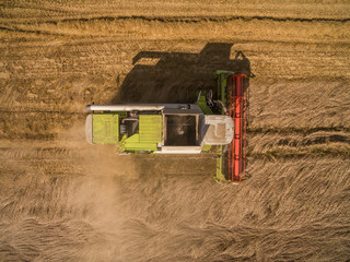 combine harvester - Aerial view of modern combine harvester at the harvesting the wheat on the...