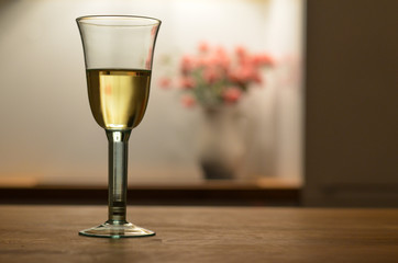 single glass of white wine shot in a nightlight