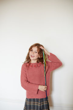 Little girl playing with a height measure