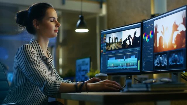 Female Video Editor Works with Footage and Sound on Her Personal Computer. Her Office is Modern and Creative Loft Studio. Shot on RED EPIC-W 8K Helium Cinema Camera.