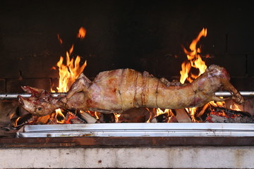 The carcass of the goat is fried on a spit