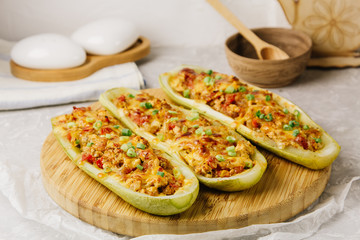 Stuffed zucchini with chicken, tomatoes and onion with cheese crust