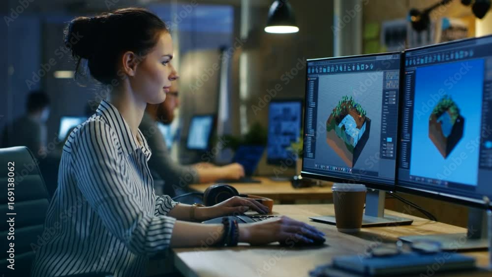 Poster Female Game Developer Works on a Level Design on Her Personal Computer with Two Displays. She works in a Creative Office Space. Shot on RED EPIC-W 8K Helium Cinema Camera.