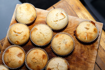 Tasty muffins colored paper on a wooden table