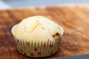 Tasty muffin colored paper on a wooden table