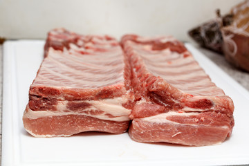 Piece of uncooked fresh meat ribbon ribs before baking