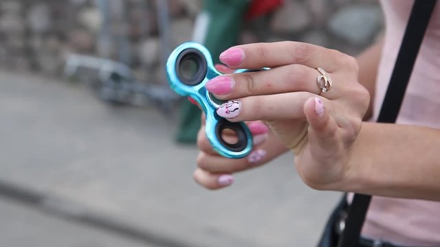 Girl playing with two Hand Spinner