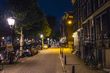 Fototapeta na wymiar The sidewalks along the canals in Amsterdam by night