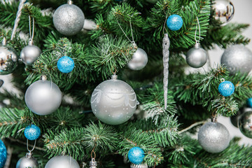 Beautiful christmas tree with blue and white ballson a white background, detaIL
