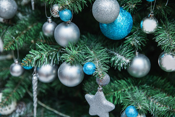 Beautiful christmas tree with blue and white ballson a white background, detaIL