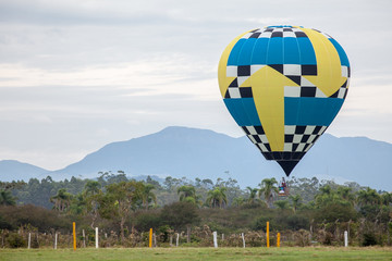 Obraz premium Balão voando com montanhas ao fundo