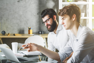 Two caucasian men working on project together