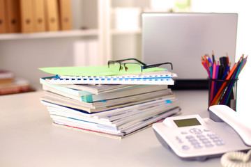 close up of stack of papers on white background