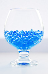 Blue little  balls in a glass