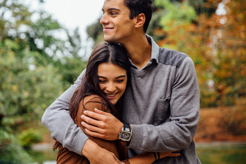 Young couple embracing in park