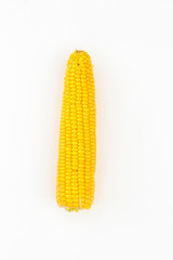 purified corn cobs on white background © mariyakuprevich