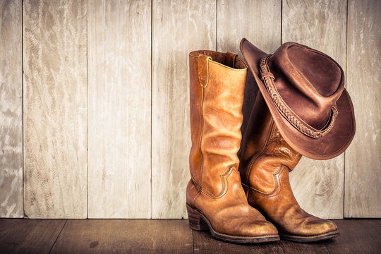 Wild West retro leather cowboy hat and old boots. Vintage style filtered photo
