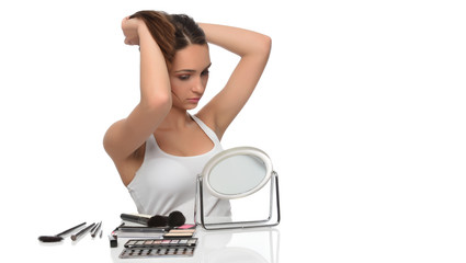Young woman combing her hair, isolated on white background