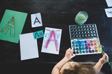 A child painting with watercolor for a homeschool activity 