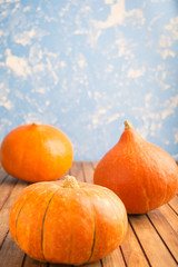 Three pumpkins on blue background