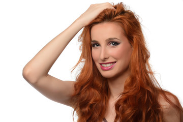 Fototapeta premium portrait of a beautiful young woman with elegant long red shiny hair looking in the mirror , hairstyle