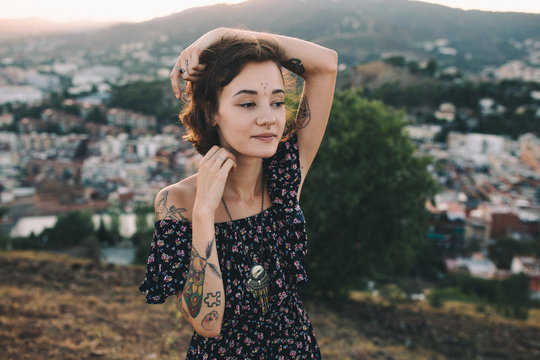 Portrait of a young girl with tattoos on a park