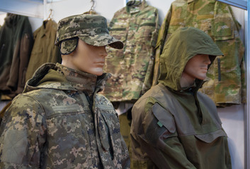 Fototapeta premium Mannequins in a camouflage military uniform in a store