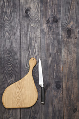 Cutting board and knife on a wood
