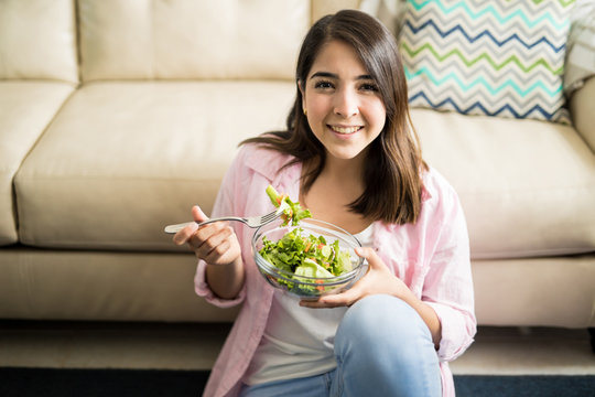 Gorgeous brunette enjoying a fresh salad