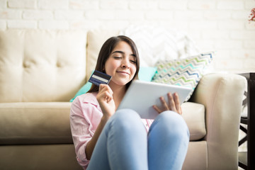 Cute woman having fun shopping online