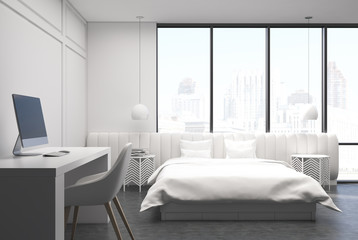 White bedroom interior with a computer