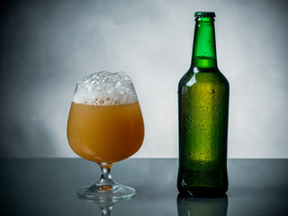 Composition of beer glass and some bottles