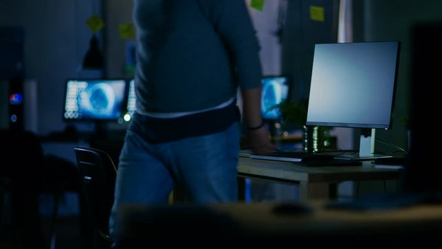 Late at Night Male Mobile Application Developer Turns off His Computers and Leaves His Working Place.Shot on RED EPIC-W 8K Helium Cinema Camera.