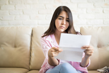 Hispanic woman worried for her payments