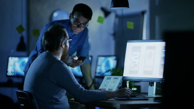 Two Male Mobile Application Developers Design and Create Quality Product. It's Late at Night They' the Only Ones Who are in the Office. Shot on RED EPIC-W 8K Helium Cinema Camera.