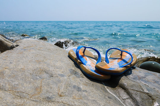 photo of summer shoes on the background of the sea