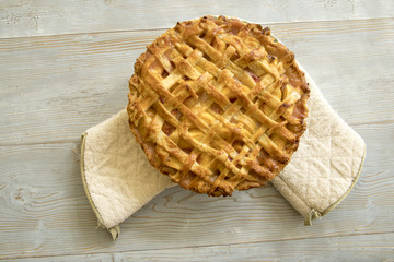 Peach pie on baking mits