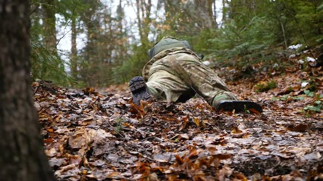 a military man fell and began to crawl slow motion