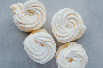 White mango marshmallows or zephyr with sugar powder on a table. Homemade sweet.