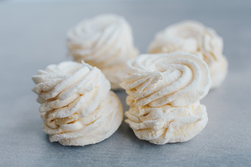 White mango marshmallows or zephyr with sugar powder on a table. Homemade sweet.