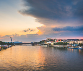 Naklejka premium Cityscape of Bratislava, Slovakia at Sunset as Seen from a Bridge over Danube River Towards Old Town of Bratislava.