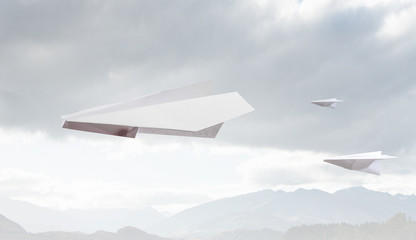 Fototapeta na wymiar Origami plane flying in sky. Mixed media