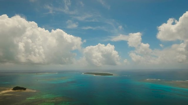 Aerial view of beautiful tropical island Daco with white sand beach. View of a nice tropical beach from the air. Beautiful sky, sea, resort. Seascape: Ocean and beautiful beach paradise. Philippines