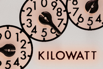 Kilowatt-hour electric meter register dials macro closeup